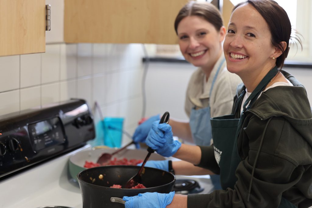 two people work at stove