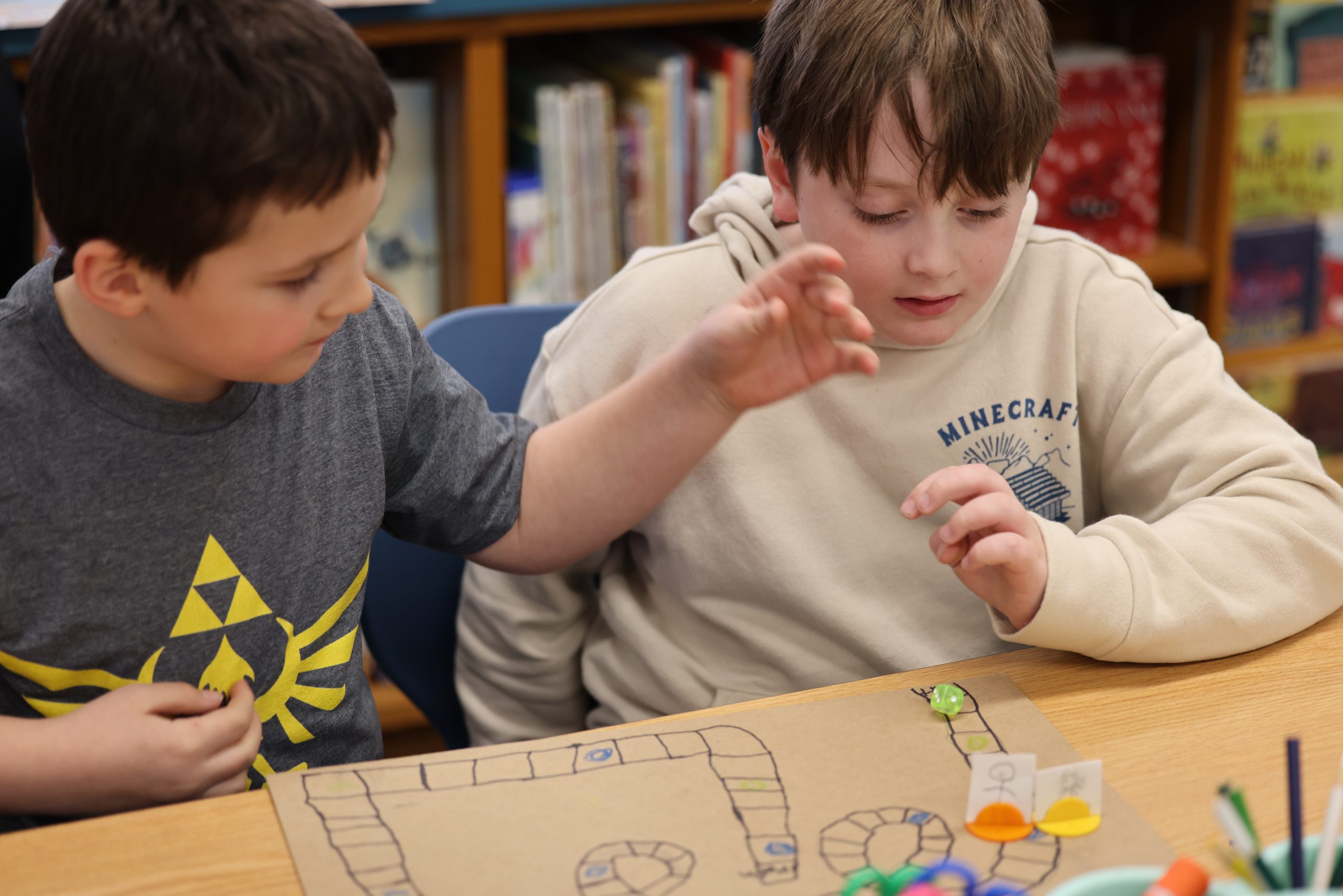 two students play board game with dice