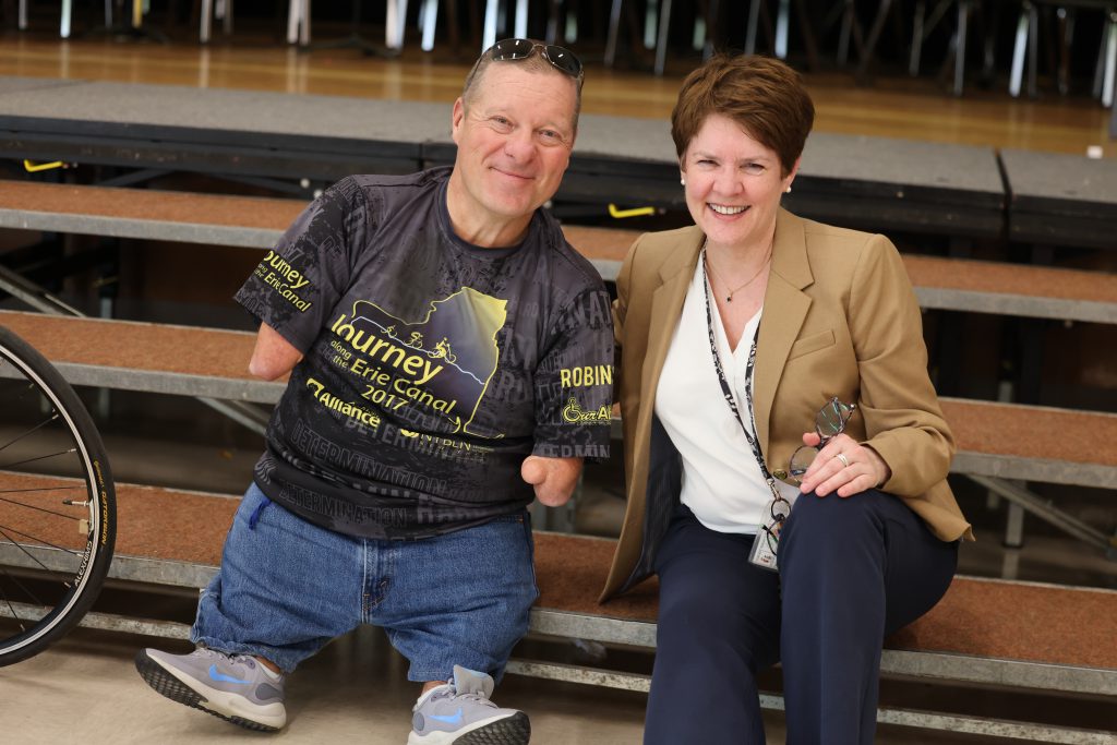 two people smile for camera