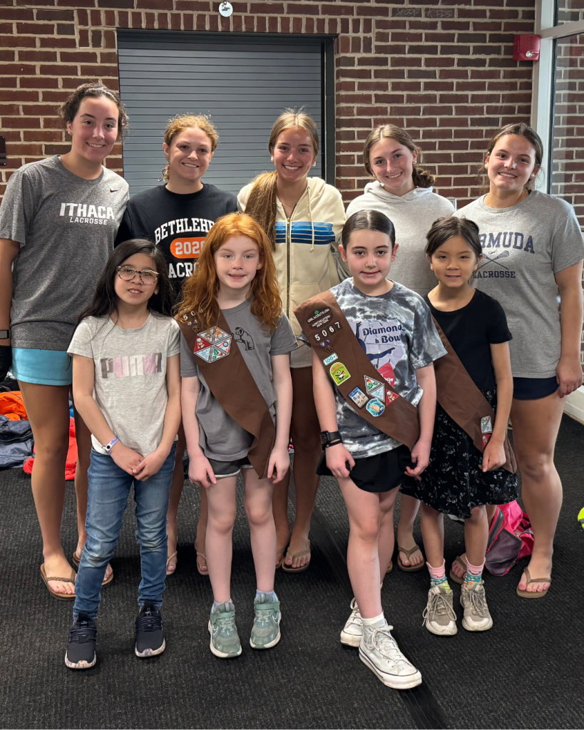 group of Girls Scouts poses for photo with group of high school students