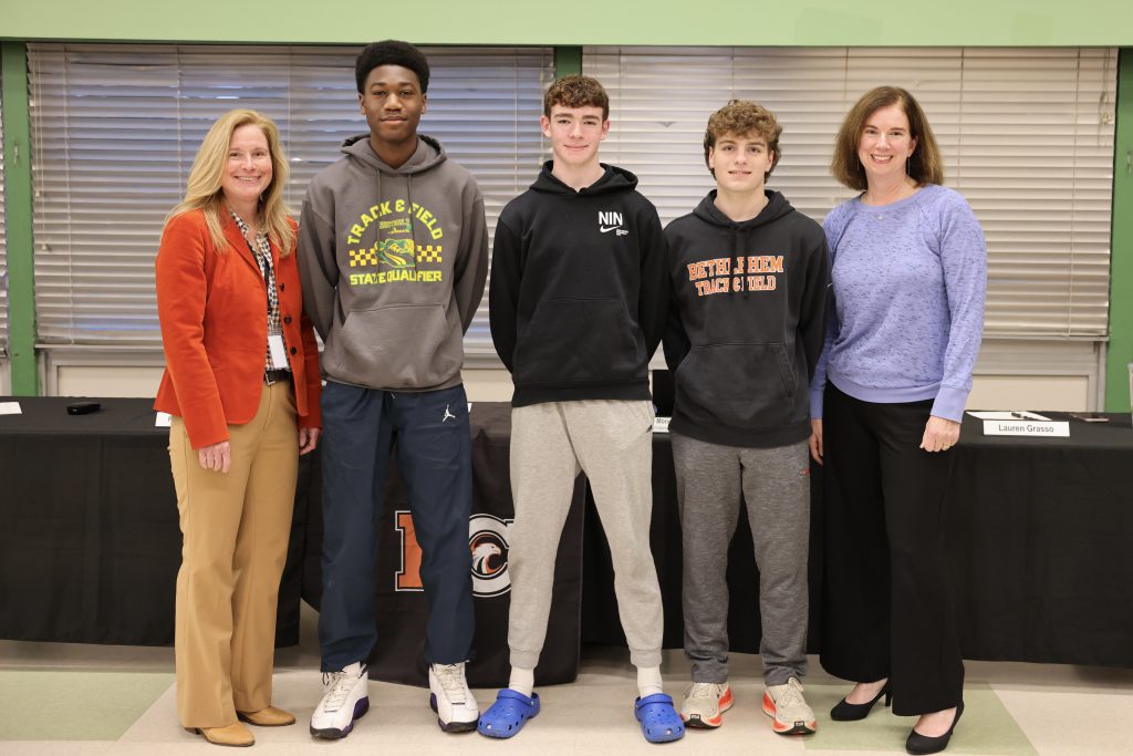 five people pose for photo
