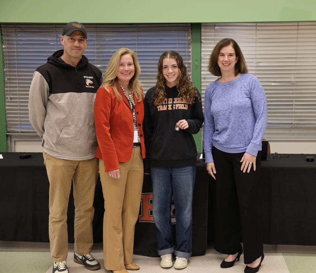 four people pose for photo