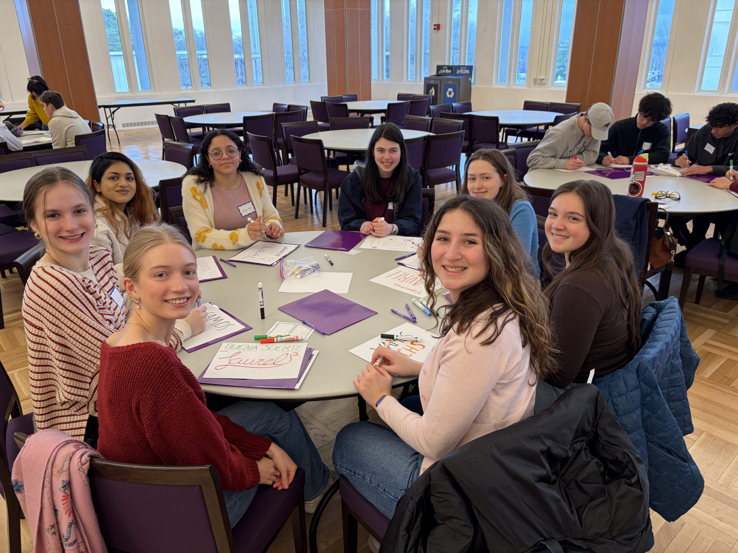 students seated at a round table
