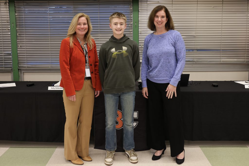 three people pose for photo
