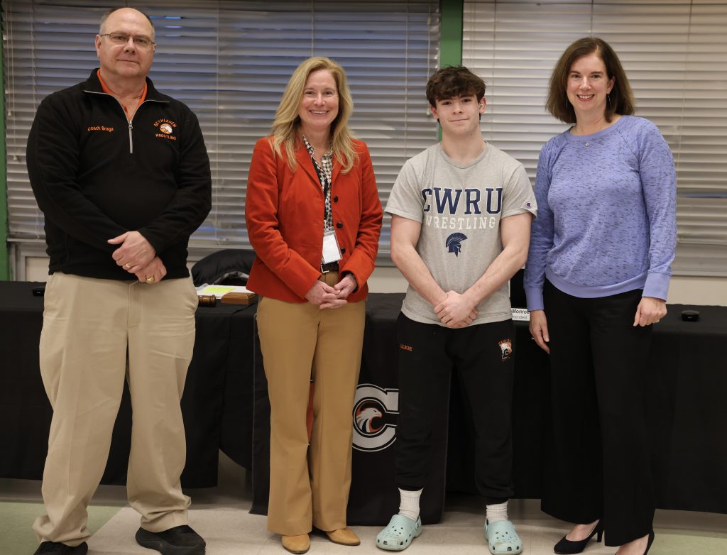 four people pose for photo