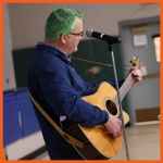 Image of Principal Baker playing guitar
