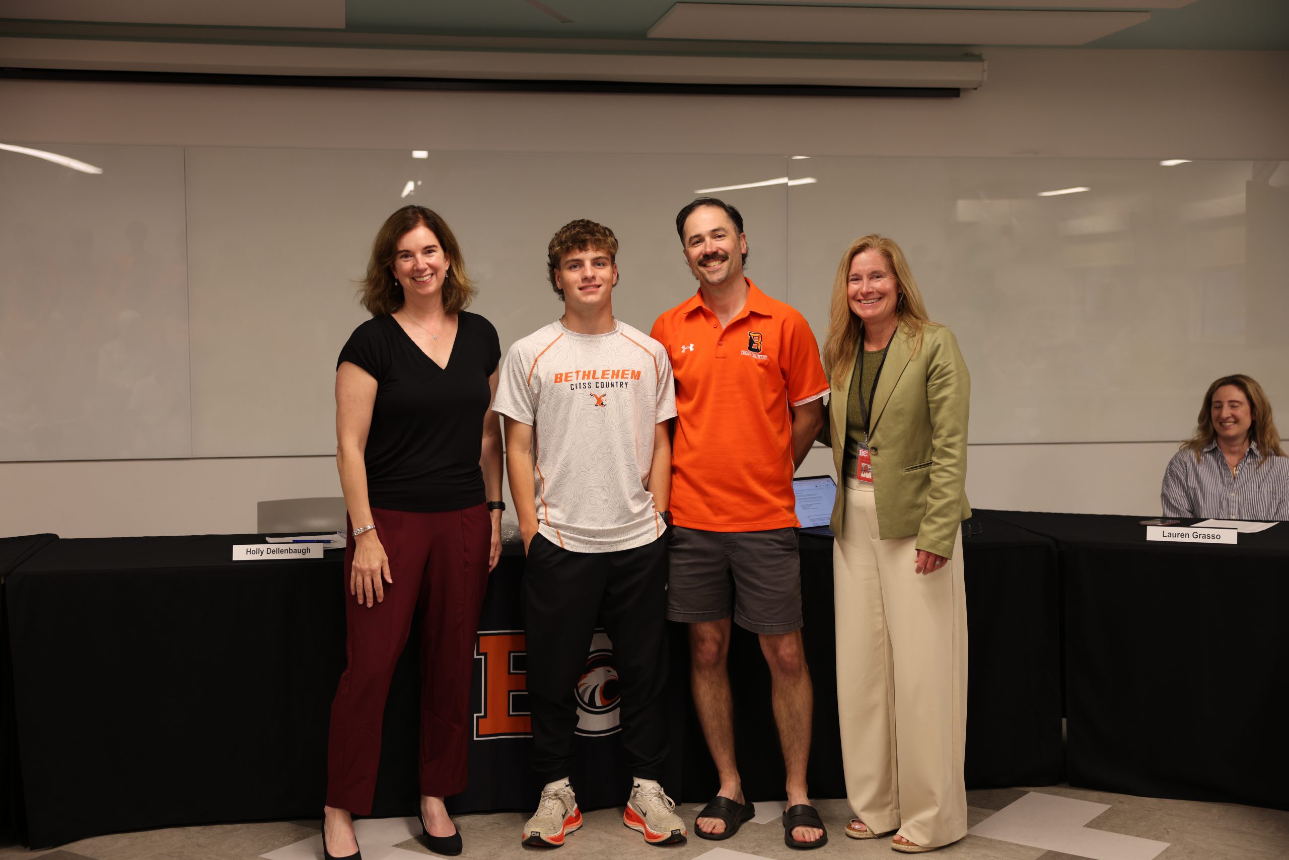 Image of Calvin Howard and Coach Andrew Rickert with BOE President Holly Dellenbaugh and Superintendent Jody Monroe