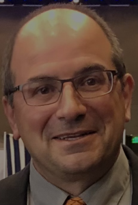person with glasses smiling