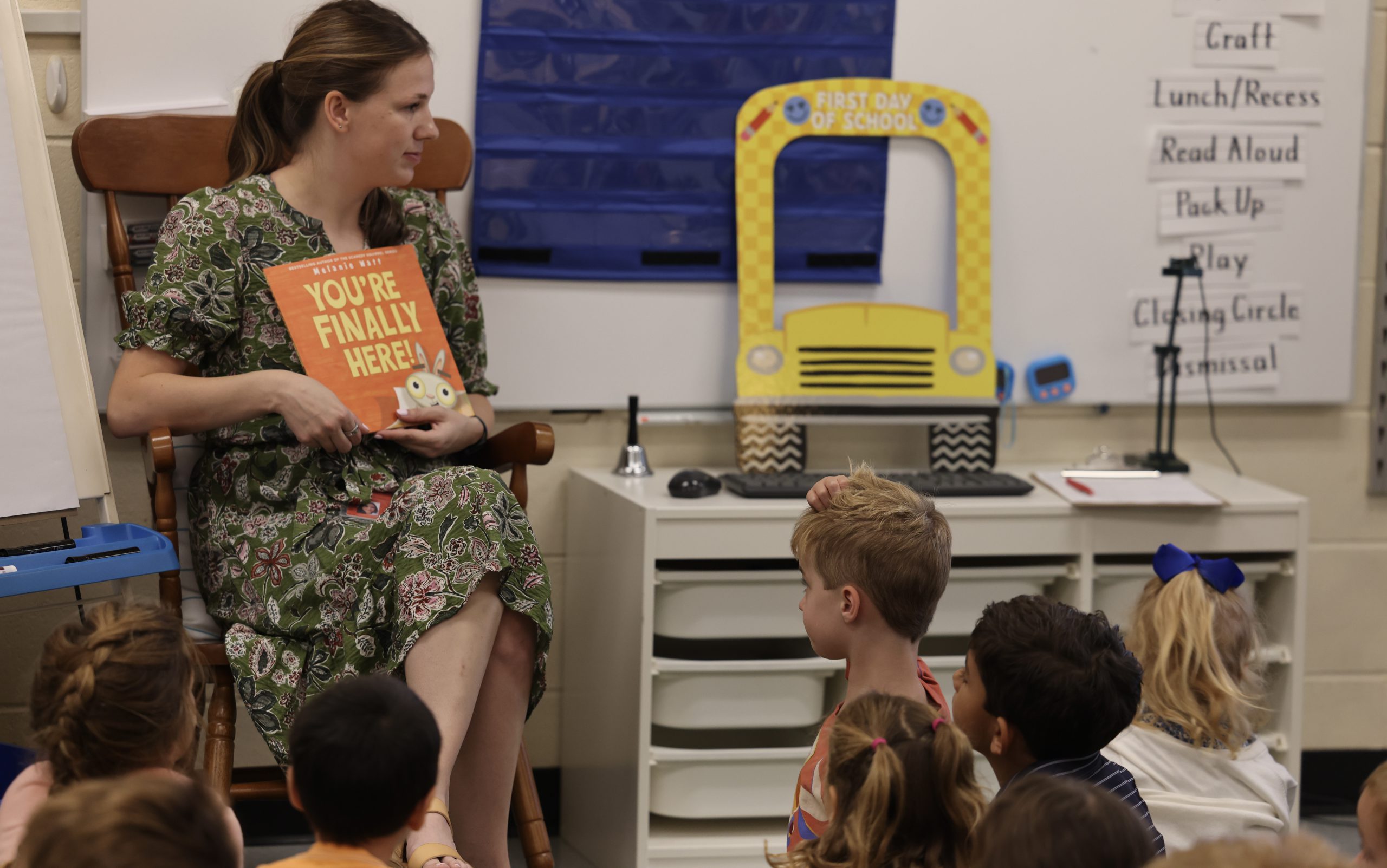 teacher reading a book to students