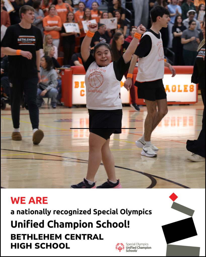 student with arms up in the air in celebration