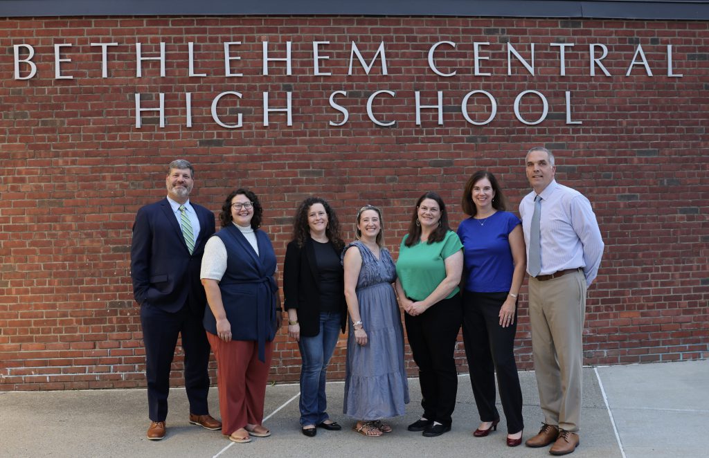 group of adults pose for photo