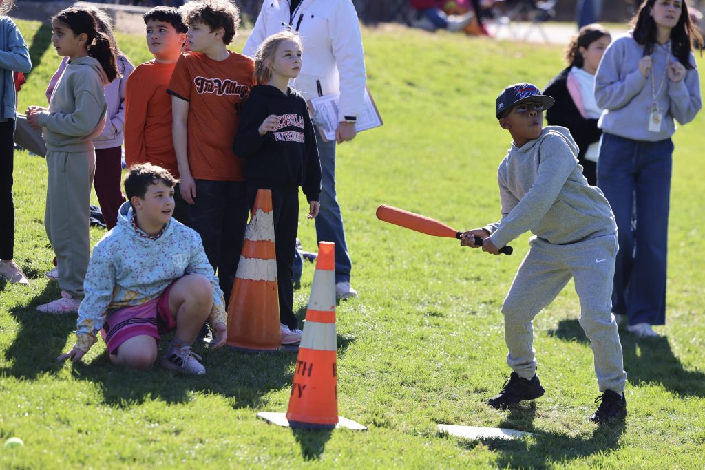 student gets ready to hit baseball