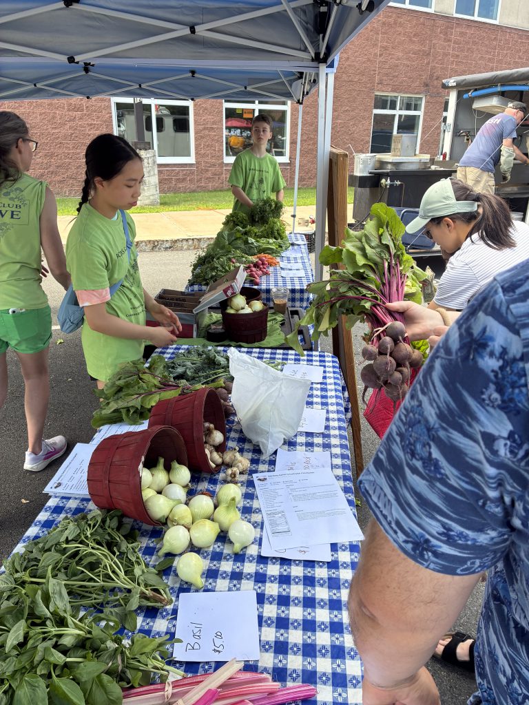 student selling produce