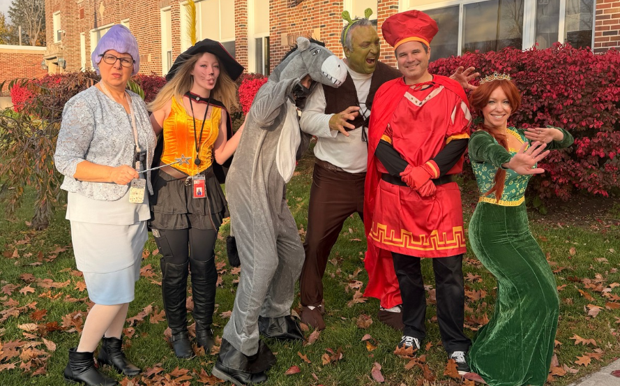 staff members dressed in halloween costumes